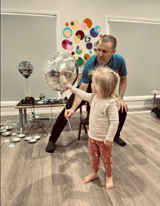 jeremy zapping a child with electricity using a foil balloon